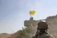 A US soldier watches members of the Syrian Democratic Forces