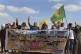 Kurdish women hold a banner with Arabic that reads, ‘We do