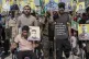 Wounded Kurdish fighters hold portraits of comrades who were