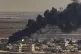 Smoke billows from fires on targets in Ras al-Ayn, Syria, ca