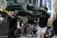 Protesters use a sling shot to launch a milk drink container