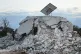 People search for victims between rubble of a destroyed hous