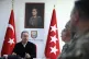 Turkish Defense Minister Hulusi Akar, right, speaks with the
