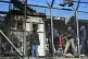 Migrants stand outside container houses in Moria refugee cam