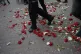 Turkish police officers walk on carnations left by demonstra