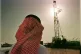 A Saudi Aramco official watches progress at a rig at the al-