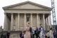 People walk through Chamberlain Square by Birmingham Town Ha
