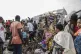 People gather at the side of an explosion in a refugee camp 