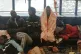 Some of the refugees rescued by the Aita Maria rest on deck.