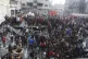 Palestinians look at the destruction after an Israeli strike