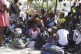 Children and their guardians gather outside a police station