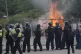 Police officers with protesters as trouble flares during an 