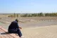 A man looks at the graves of those killed by Saddam Hussein�