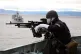 A gunner on board HMS Sutherland takes part in a Nato war ga