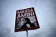 A woman holds a placard with a picture of Iranian woman Mahs