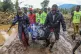 Kenya Red Cross workers and volunteers carry a man's body af