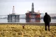 Oil platforms stand amongst other rigs which have been left 