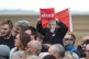 A supporter wears a Jeremy Corbyn mask as they listen to the