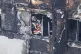 A firefighter investigates a floor after a fire engulfed the