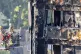 Firefighters observe the wreckage of Grenfell Tower