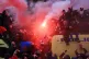 Fans on top of a Police van and flares being let off before 