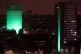 Grenfell Tower (left) in west London is illuminated in green