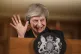 Prime Minister Theresa May waves during a press conference a