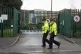 Police officers walk past a school l in Huddersfield where t