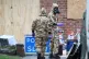 Members of the military wear protective clothing as work con