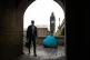 A man walks by a tent of a homeless person near the Houses o