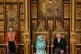 Elizabeth and Charles Windsor sit on gold thrones in the Pal