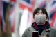 A woman wears a face mask in Parliament Square, London. Many