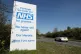 A car makes it's way past a sign in support of the NHS put u