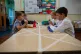 Children of essential workers eat lunch in segregated positi