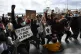 People take part in a Black Lives Matter protest rally outsi