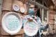 Protestors hang up paper plates carrying slogans calling for
