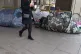 A woman walks past tents of the homeless in Victoria, London
