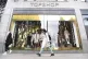 A woman walks past Topshop, owned by the stricken Arcadia gr