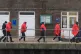 A group of people thought to be migrants are brought in to D