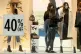 A worker dresses a mannequin in a shop window