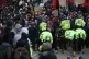 Police horses are deployed as they hold back people outside 