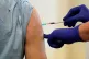 A patient receiving a Covid-19 vaccine booster