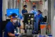 Medical staff wearing PPE work in a corridor on a ward for C