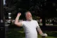 A man throws eggs at a statue of Margaret Thatcher as it is 