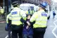 Police remove activists from Just Stop Oill during their pro