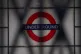 A sign for the London Underground seen through the closed sh