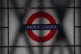 A sign for the London Underground seen through the closed sh