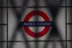 A sign for the London Underground seen through the closed sh