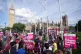 Demonstrators listen to a speaker at a protest against the I
