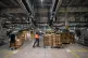 Workers move cardboard shipping boxes at Amazon's fulfillmen